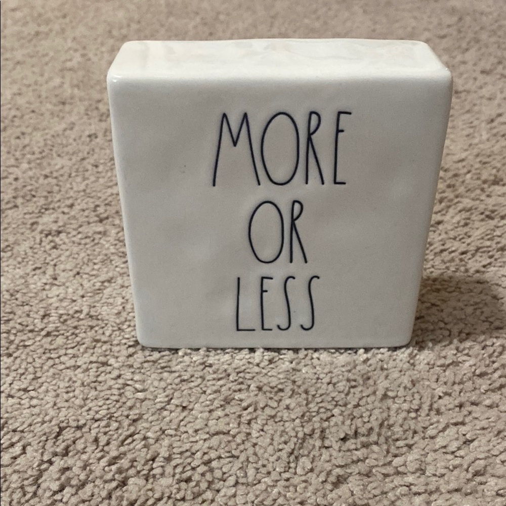 White Ceramic Block with 'More or Less' Text